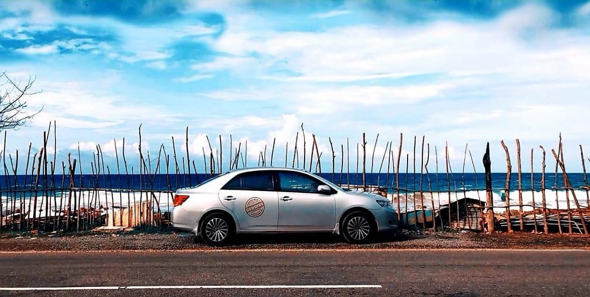 Placeholder: a car on the coast road in Sri Lanka